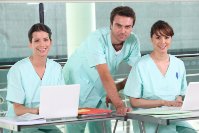 Smiling nurses sitting at a desk